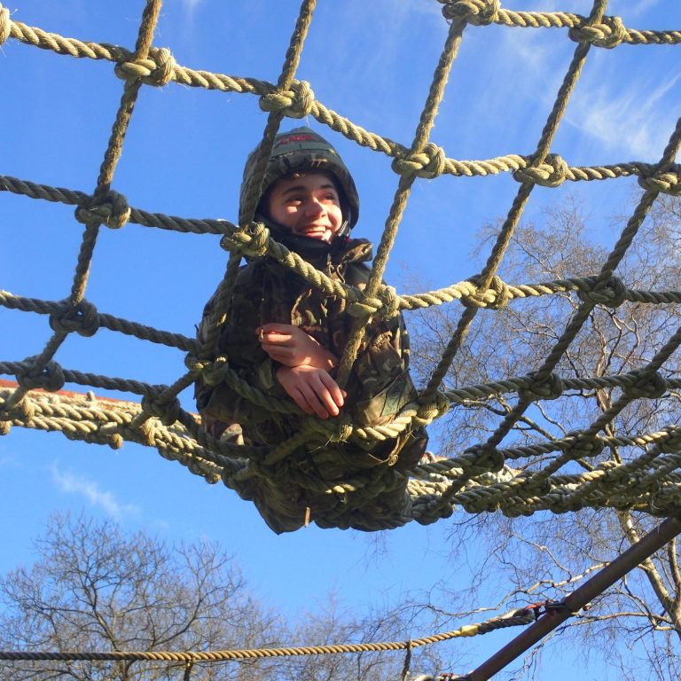 child sitting on a rope net