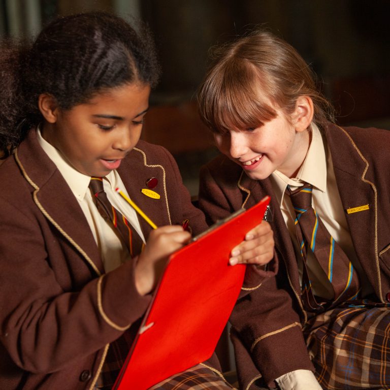 girls using a clipboard