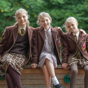 3 girls sat on a bench