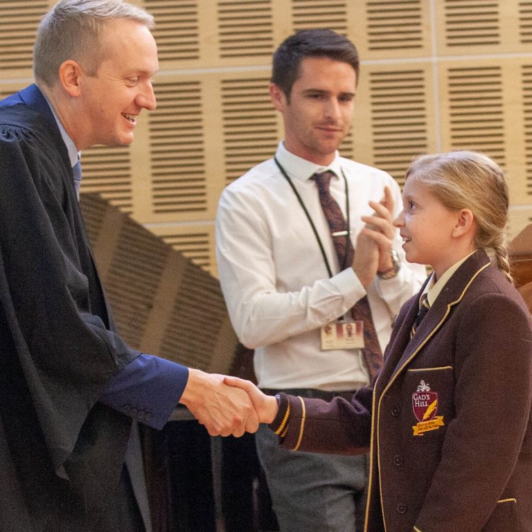 teacher shaking hands with pupil