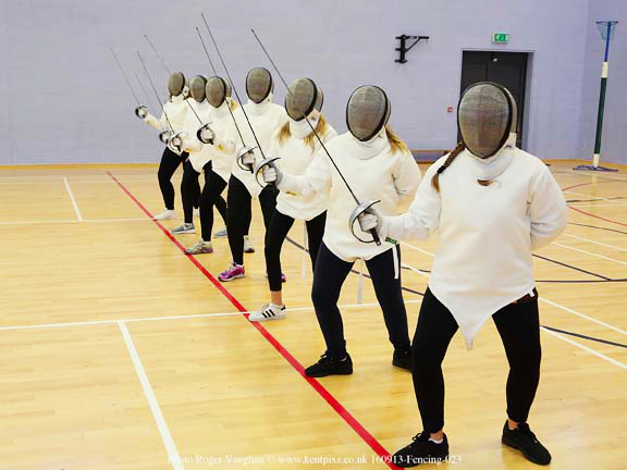 children in fencing costumes